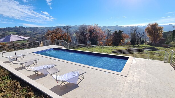 Une piscine rectangulaire offrant une vue sur un paysage montagneux.