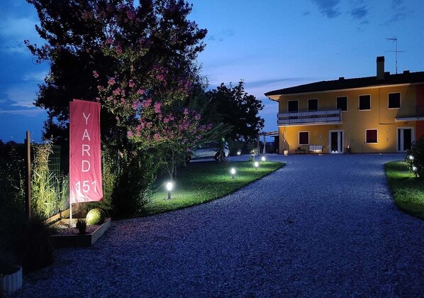 A gravel driveway leading to a building with a sign reading "YARD 151".