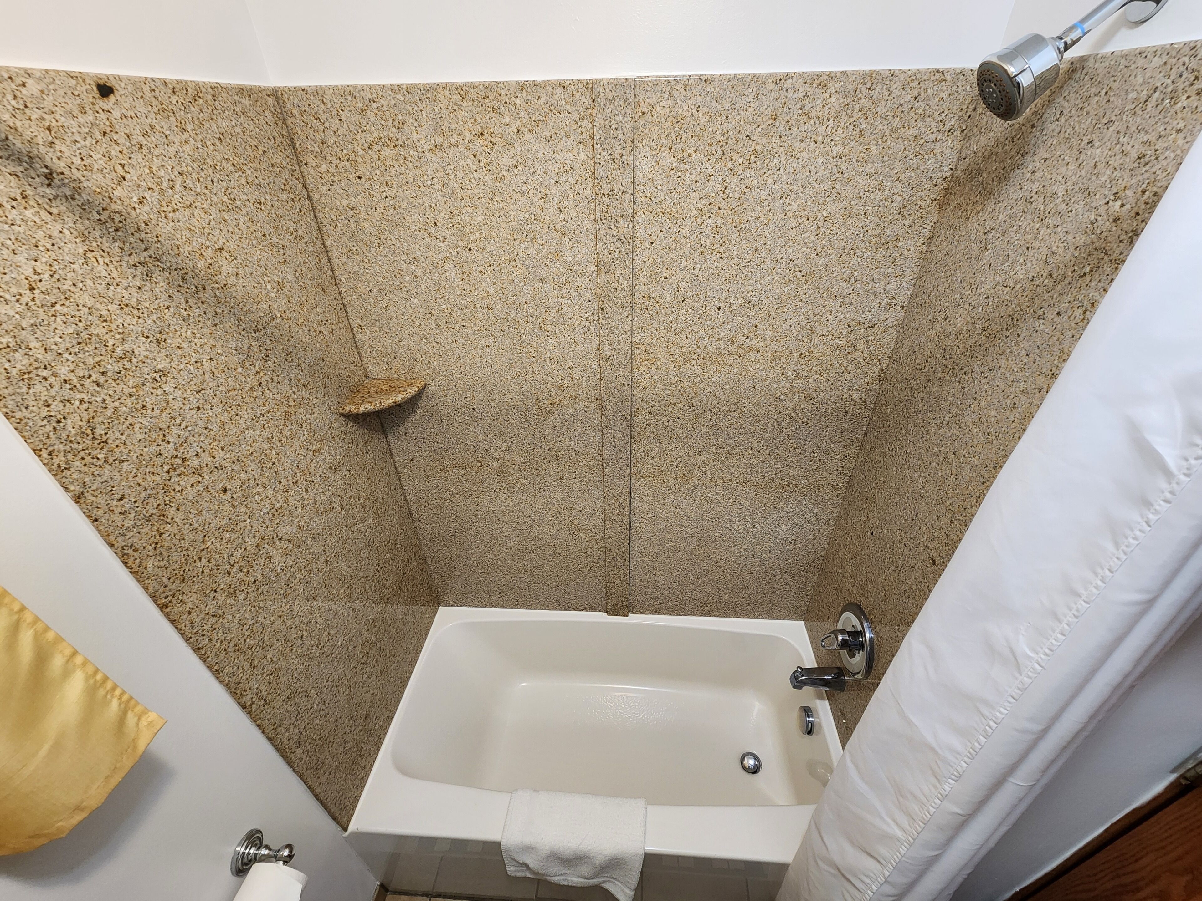 A bathroom with a bathtub, a shower, and a toilet.