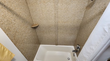 A bathroom with a bathtub, a shower, and a toilet.