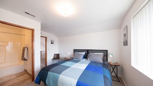 A bedroom with a bed, a nightstand, a chair, a desk, and a window. - Large House on a Hill- 15 Min Walk 2 Bart (Richmond)