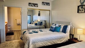A bedroom with a bed, a bedside table with a lamp, a mirror, and a clock. - Paradise on Wolf Creek by Mesquite Vacation Rentals with Golf Course View and $510 in free daily activities (Mesquite)