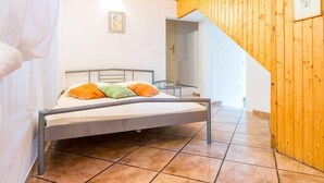 A bedroom with a bed, a wooden ceiling, and a tiled floor. - near Dubrovnik City Walls (Dubrovnik)