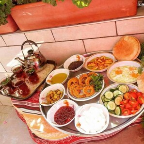 A table with various dishes and a teapot, suggesting a meal setting.