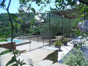 A backyard with a swimming pool, a pergola, and outdoor furniture. - Barn completely renovated stone country with private pool. (Berlou)