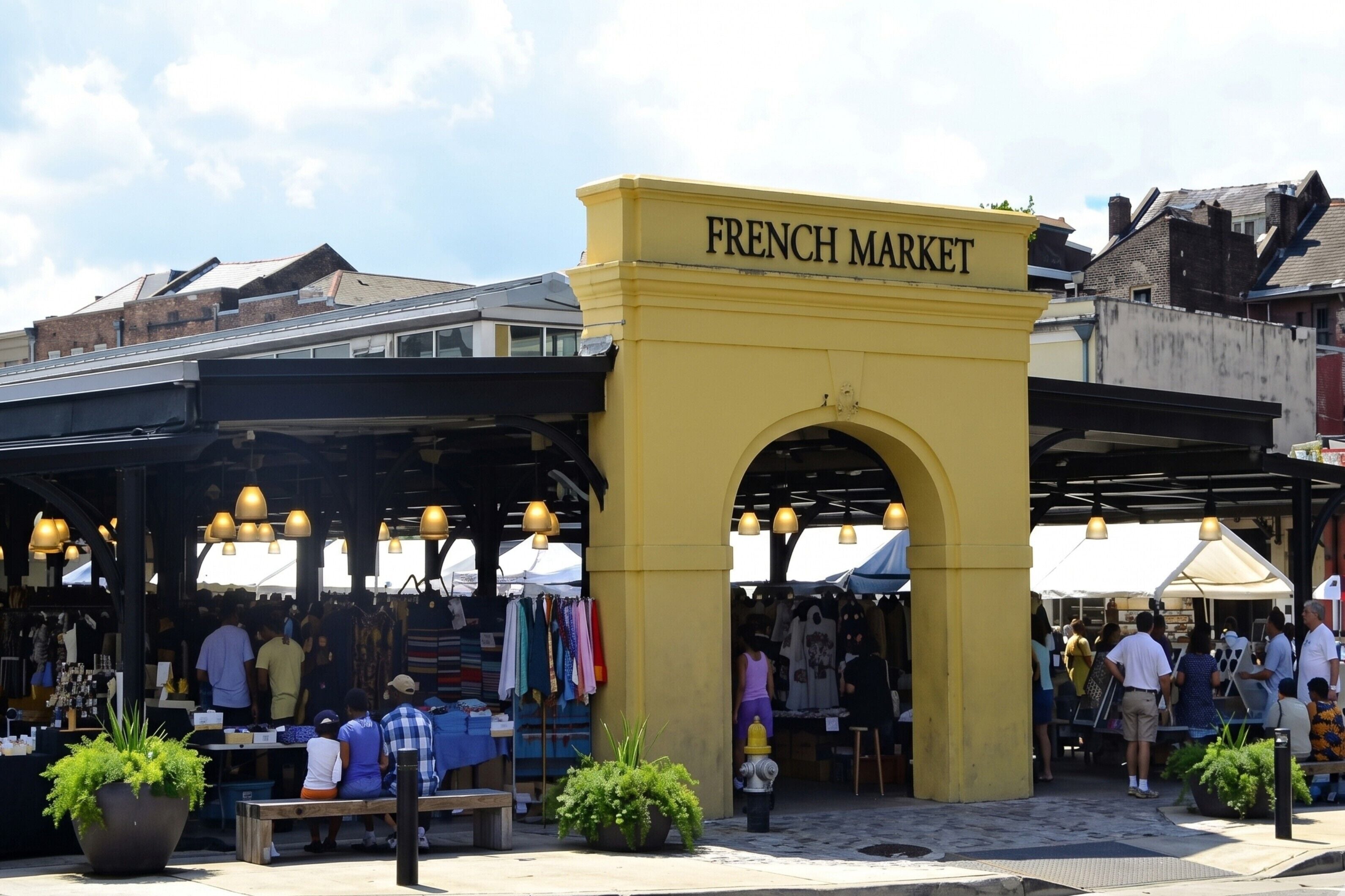 A market with a yellow archway labeled 'FRENCH MARKET,' various stalls, and people browsing.