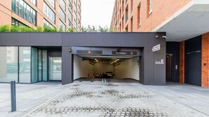 Ingresso moderno di un edificio con un parcheggio indicato come 'Parking - 1'.