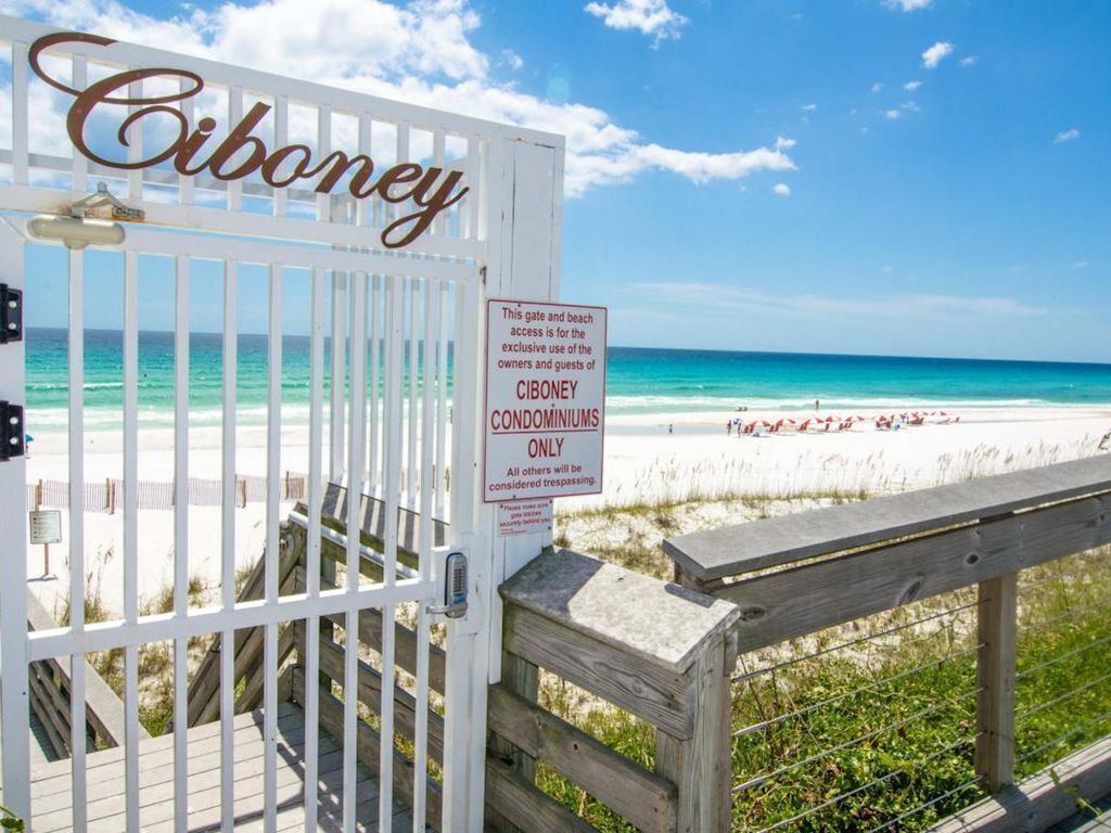 A gated entrance to a beach area labeled "Ciboney Condominiums Only" with a sign restricting access to condominium residents.