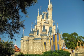 A castle-like structure with multiple towers and spires, surrounded by greenery. - 1533 Dream (Clermont)