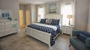 A bedroom with a bed, nightstands, a dresser, a chair, and a painting on the wall. - 4201 Solterra (Davenport)