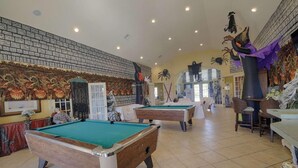 A pool hall with two pool tables, a brick wall mural, and Halloween decorations. - 4562 Seven Dwarfs (Kissimmee)