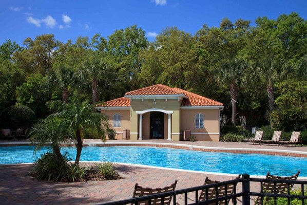 Set amidst lush greenery, this resort-style building offers a tranquil atmosphere and access to a swimming pool area with lounge chairs.