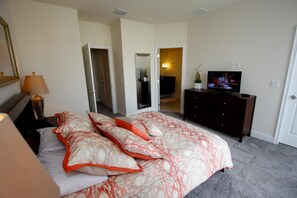 A bedroom with a bed, a dresser, a television, and a mirror. - 1521 Dream (Clermont)