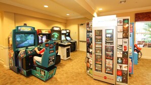 Ein Raum mit Spielautomaten, einer DVD-Verleihstation und einer Tür zu einem weiteren Bereich.