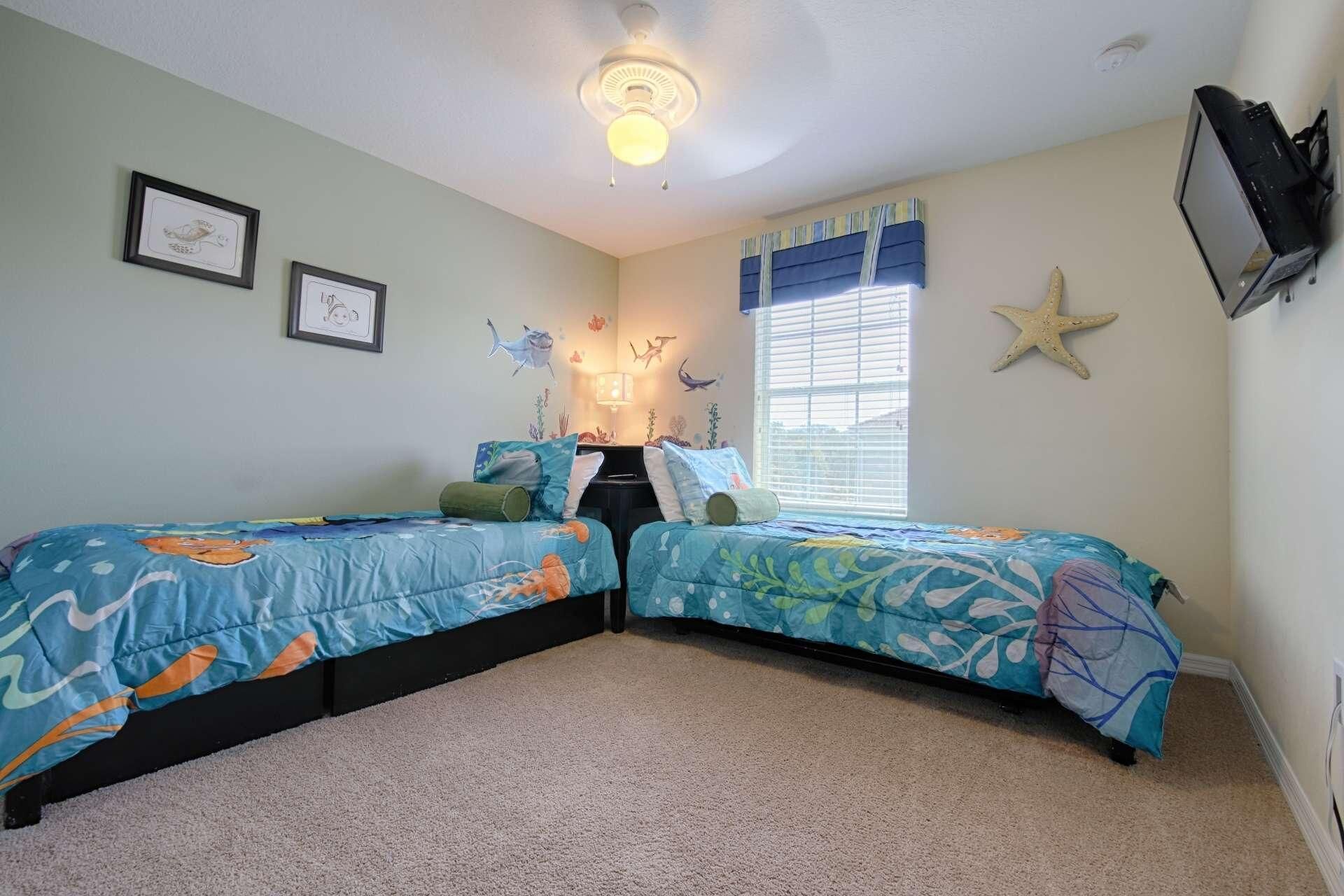 A bedroom with two beds, a ceiling fan, a window with blinds, and a starfish decoration.