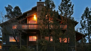 A two-story log cabin with a balcony, surrounded by trees. - Walk 2 Ski/Hiking/Biking Trails w/Spa/Pool Table/Sauna/Fenced Yard, Pet Friendly (Big Bear Lake)