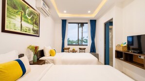 A hotel room with a large bed, a TV, a small table with chairs, and a window with curtains. - 5 Coconut Homestay Hoi An (Da Nang)