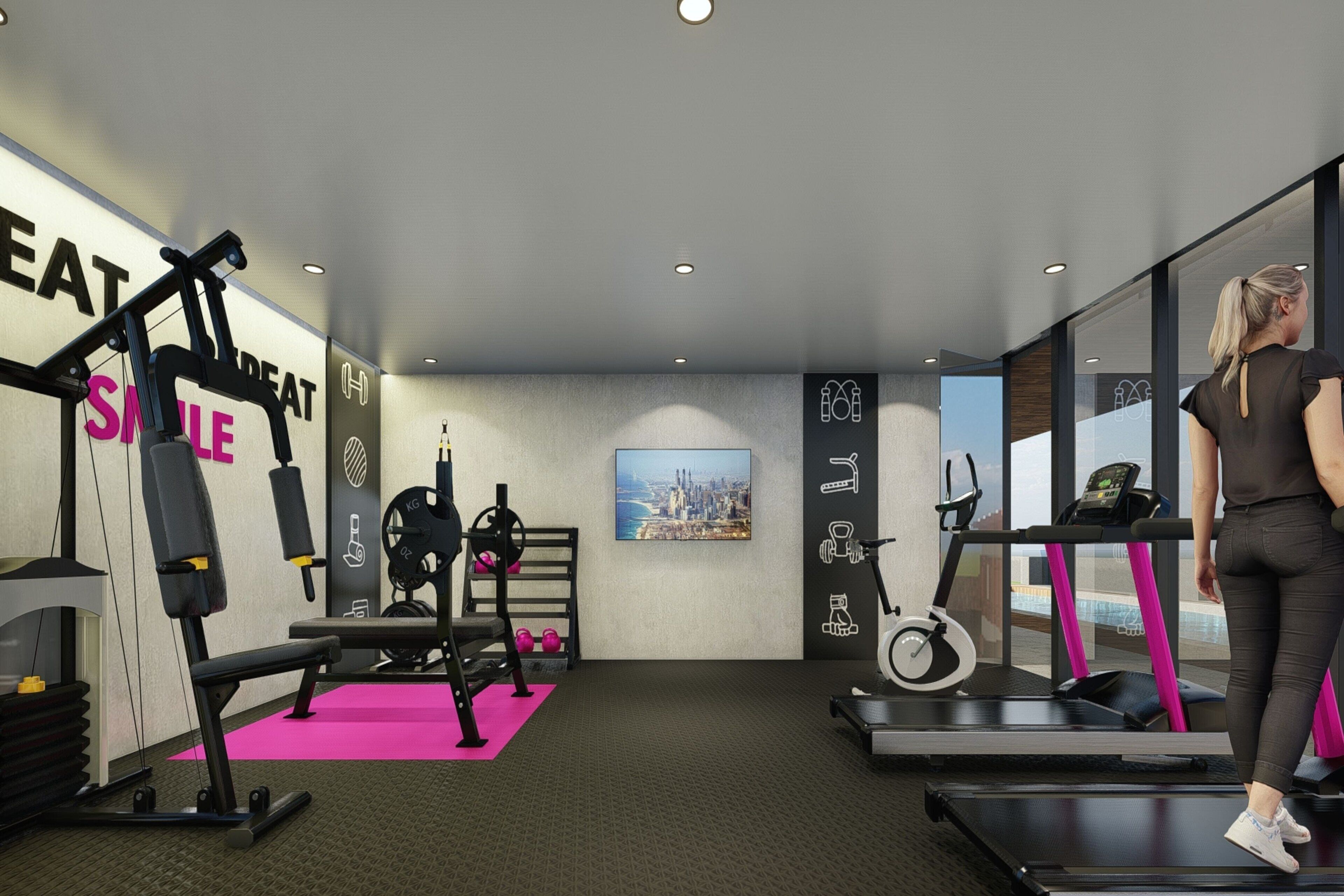 A modern gym with exercise equipment, a treadmill, and a pink mat.
