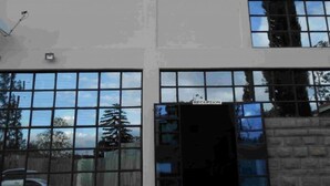 A building with a reception area, large windows, and a satellite dish.