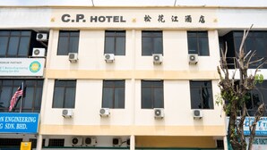 A hotel building with multiple air conditioning units, a flag, and signage for C.P. HOTEL and another business. - OYO 89461 CP Hotel (Butterworth)