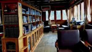 A library with bookshelves and a computer desk. - Lukla Airport Resort, Lukla  (Lukla)