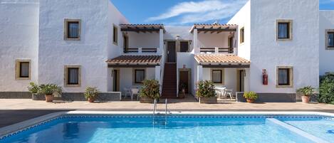 Seasonal outdoor pool, open 9:00 AM to 9:00 PM, pool umbrellas