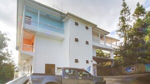 A multi-story building with a balcony on the second floor.