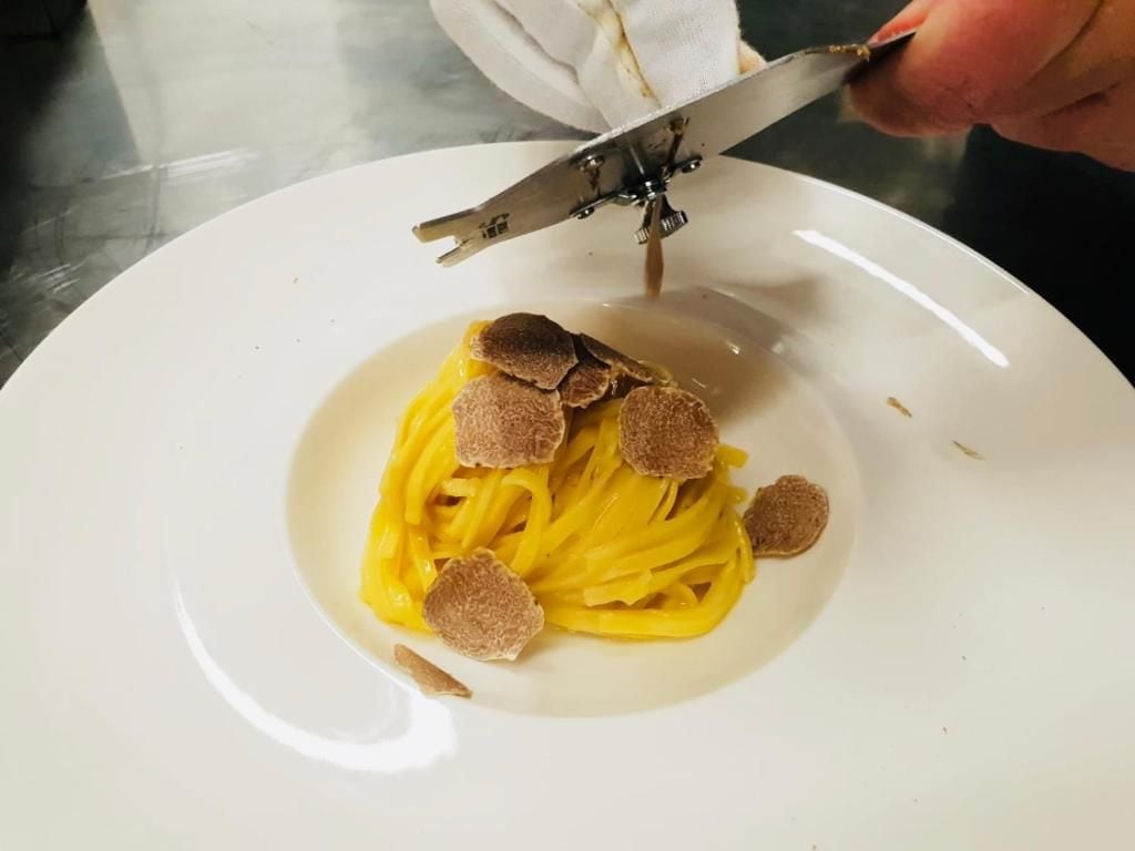 A plate of spaghetti with truffle slices.