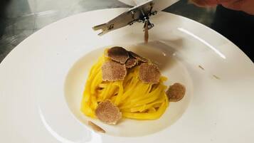 A plate of spaghetti with truffle slices.