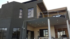 A modern two-story building with a balcony, large windows, and a flat roof. - Naldorado Executive Villa (Mbombela)