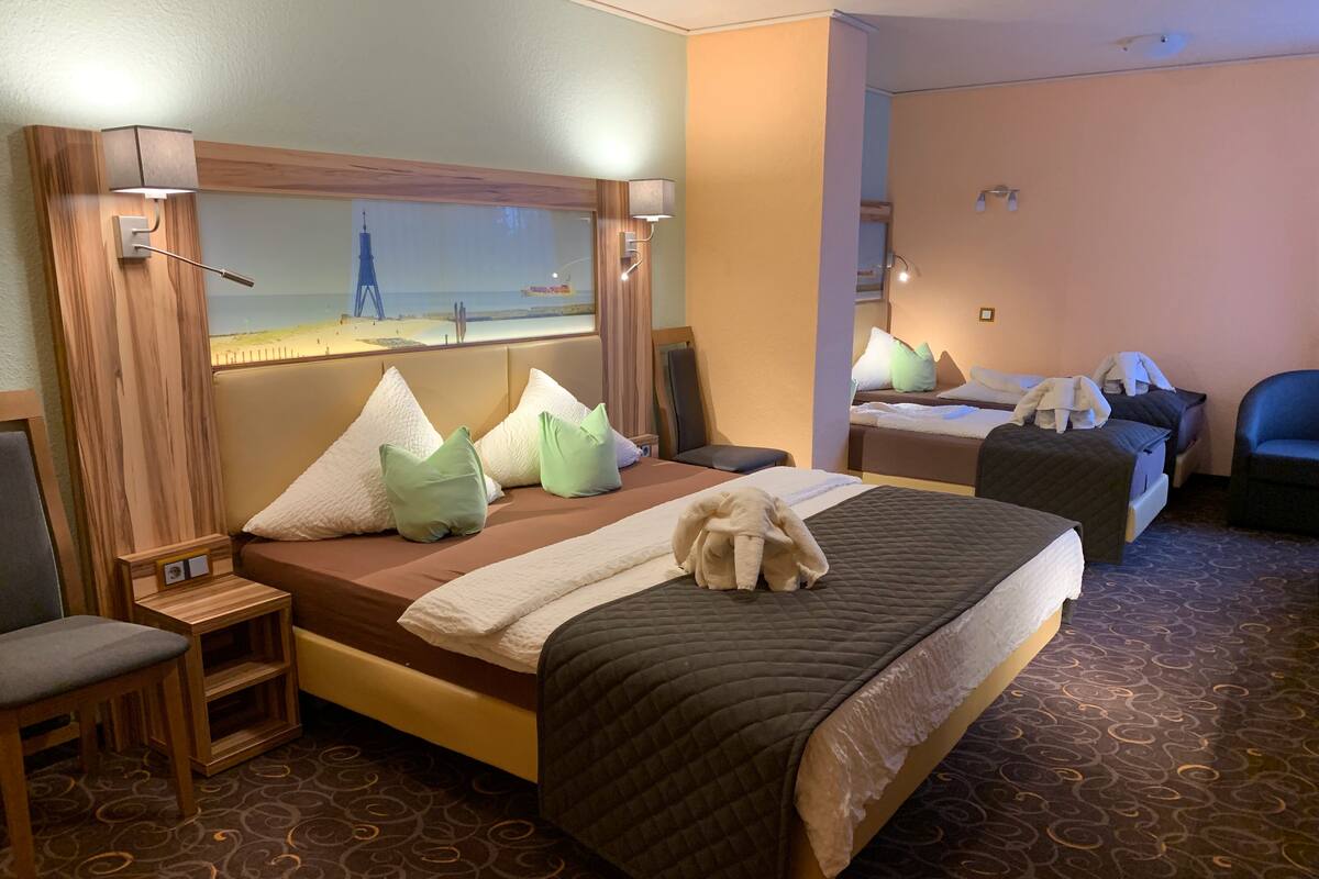 Standard Quadruple Room | In-room safe, desk, laptop workspace, blackout drapes