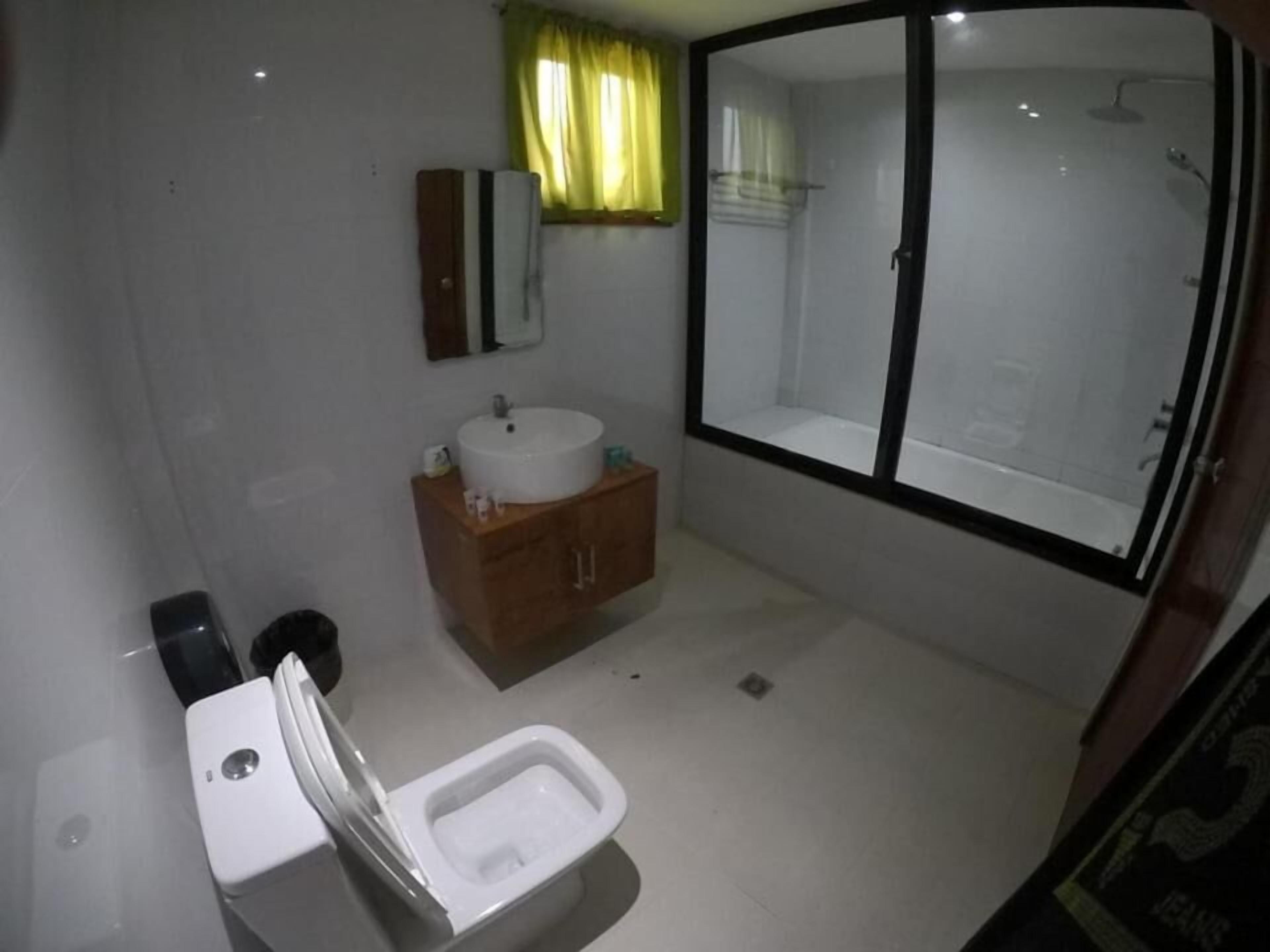 Ein kleines Badezimmer mit Toilette, Waschbecken und Spiegel.