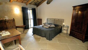 Ein Schlafzimmer mit Bett, Schreibtisch, Stuhl und Kleiderschrank.