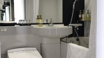 A modern bathroom with a white toilet, a sink, a mirror, and a shower.