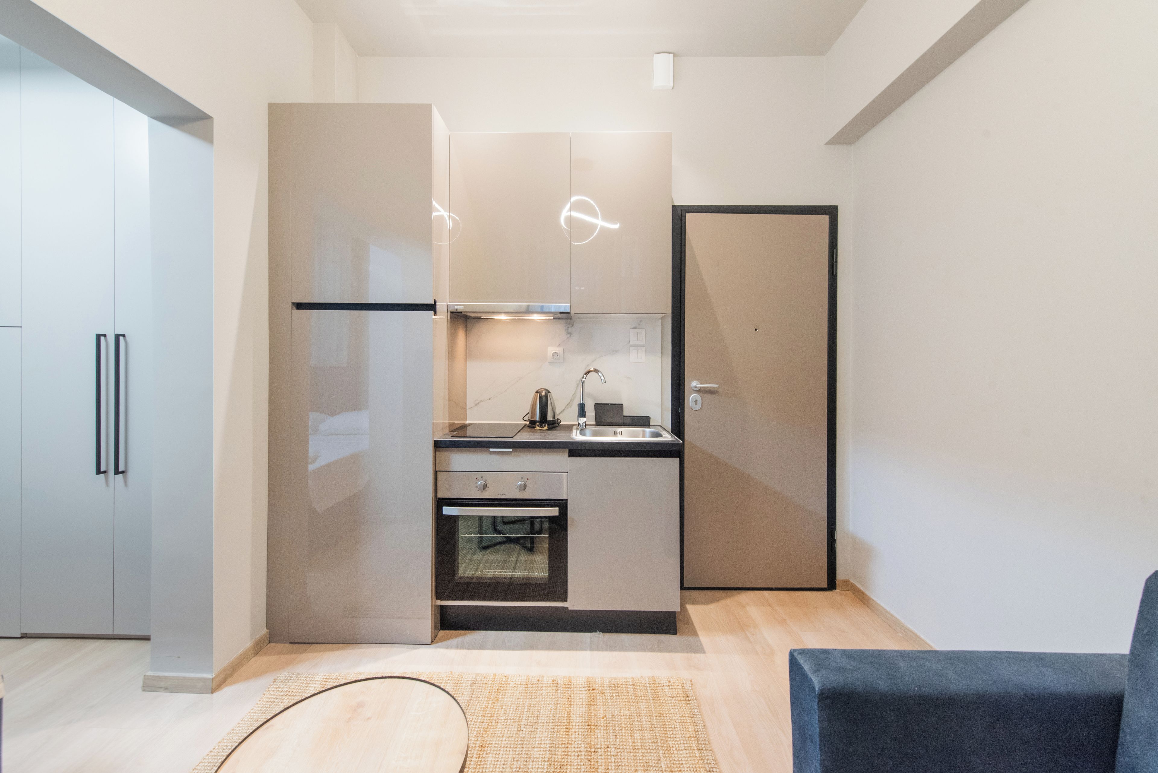 A compact kitchen with modern appliances, a built-in oven, and a microwave.