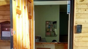 A wooden door with a metal handle and a sign above it. - Hostel Tarnopil (Ternopil)