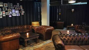 A lounge area with leather sofas, a wooden coffee table, and a patterned rug.
