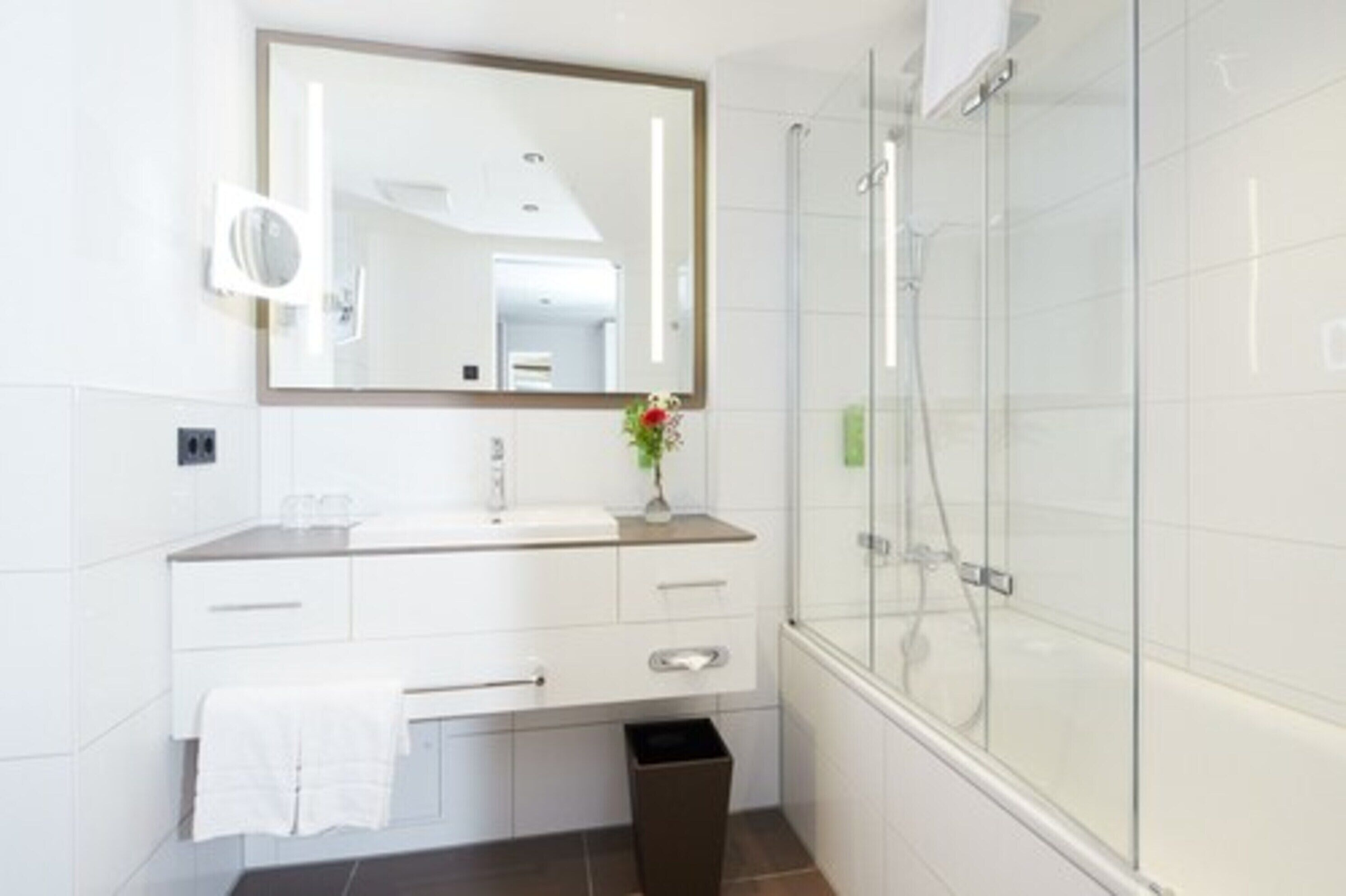 deep-soaking bathtub, rainfall showerhead, hair dryer, towels