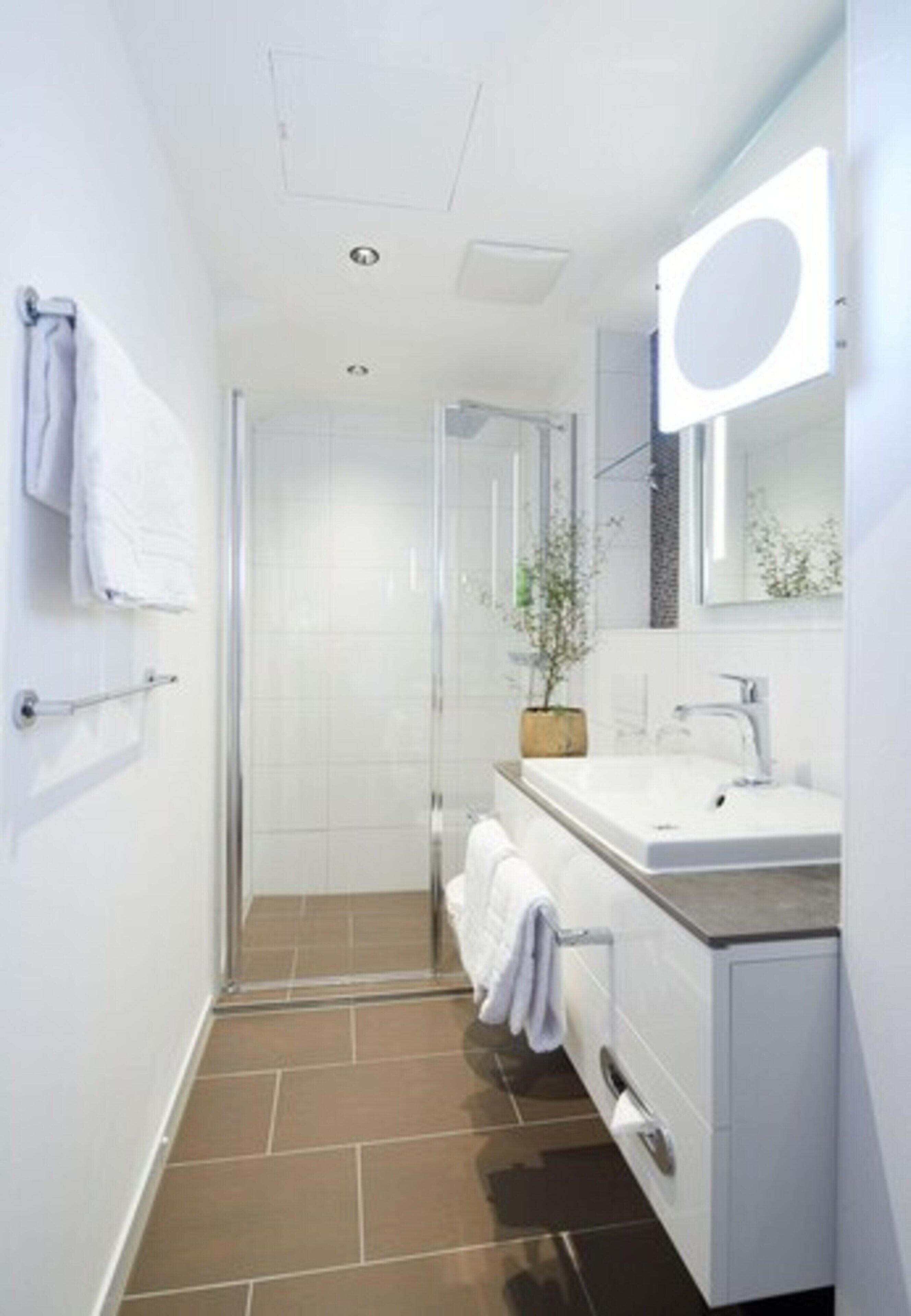 deep-soaking bathtub, rainfall showerhead, hair dryer, towels