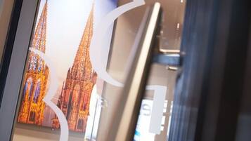 A glass door with a reflection of a cathedral's spires.