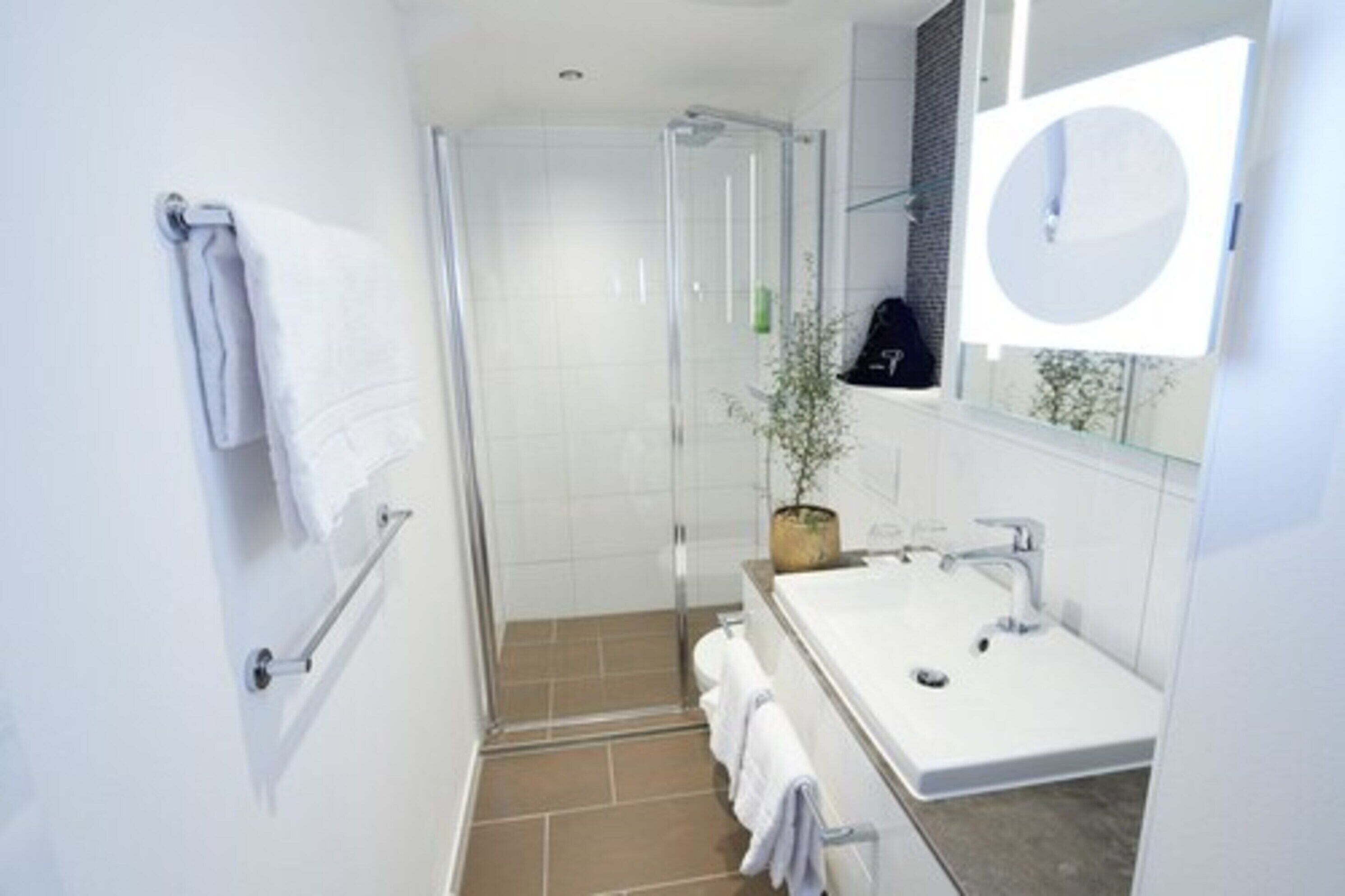 deep-soaking bathtub, rainfall showerhead, hair dryer, towels