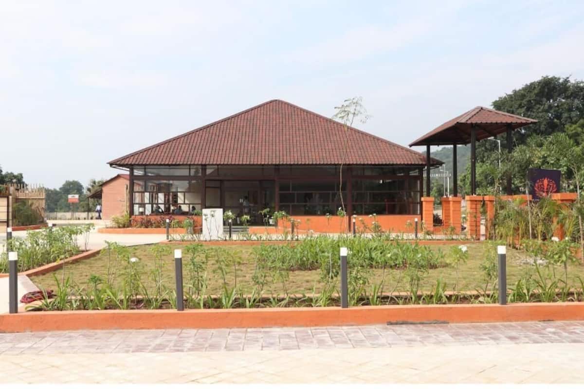 A building with a red roof, large glass windows, and a covered outdoor area.