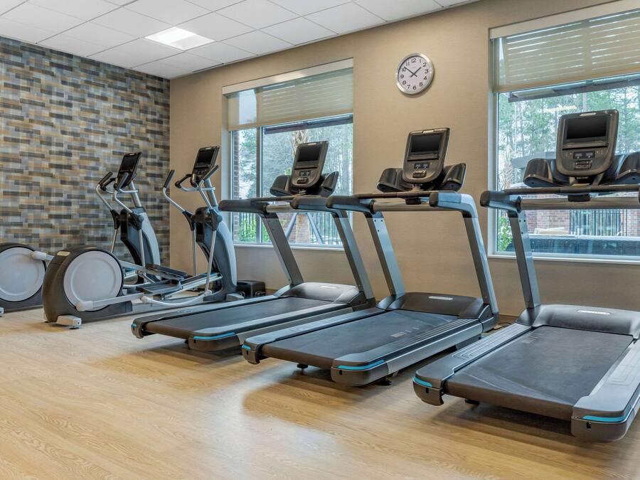 A gym with treadmills, ellipticals, and stationary bikes.