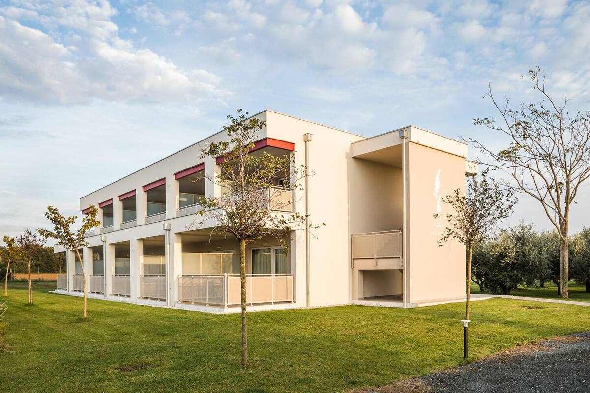A modern building with a flat roof, large windows, and a flat facade.