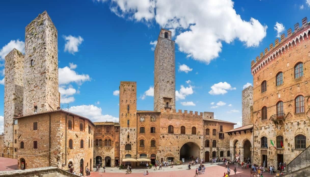 A historic building with multiple towers and arched walkways.