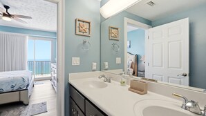 A bathroom with a double sink, a ceiling fan, and a large mirror. - Relaxing Beachfront Condo with Beach Access - Unit 1603 by RedAwning (Panama City Beach)