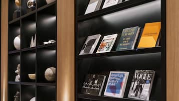 A bookshelf with various books and decorative items.
