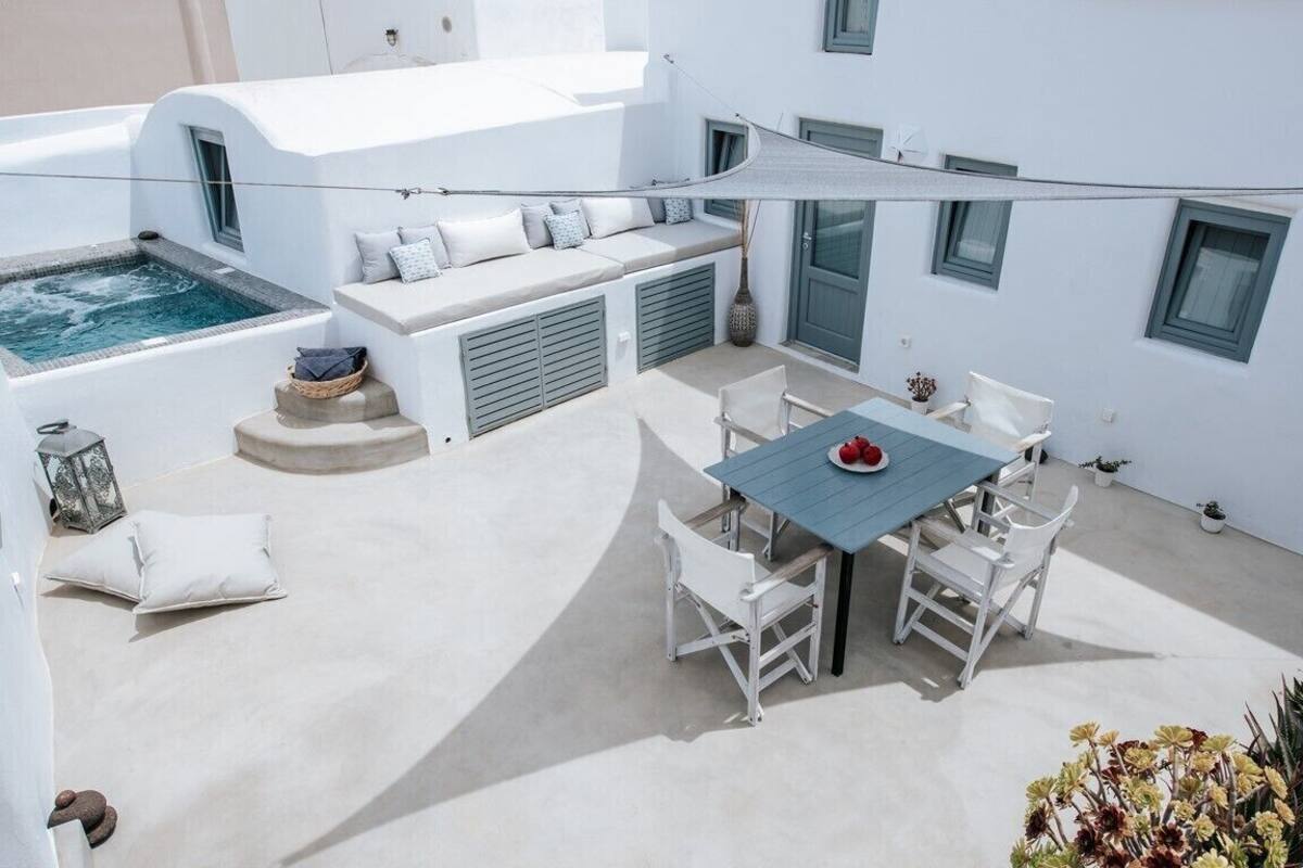 A rooftop terrace with a pool, seating area, and dining setup.