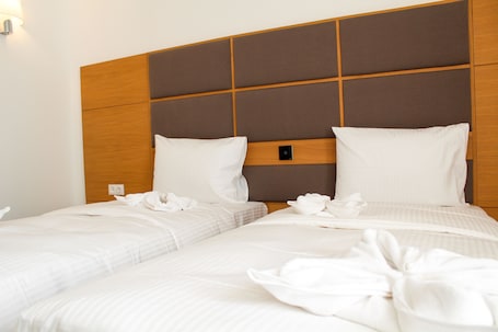 Standard Twin Room | Minibar, desk, laptop workspace, blackout drapes