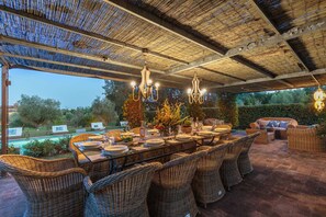 An outdoor dining area with wicker furniture, a pool, and a view of the surrounding landscape. - RENAISSANCE WINERY VILLA AMONG THE VINEYARDS, 9 BEDROOMS, 7 BATHS, WIFI, AIR CON (Lucca)